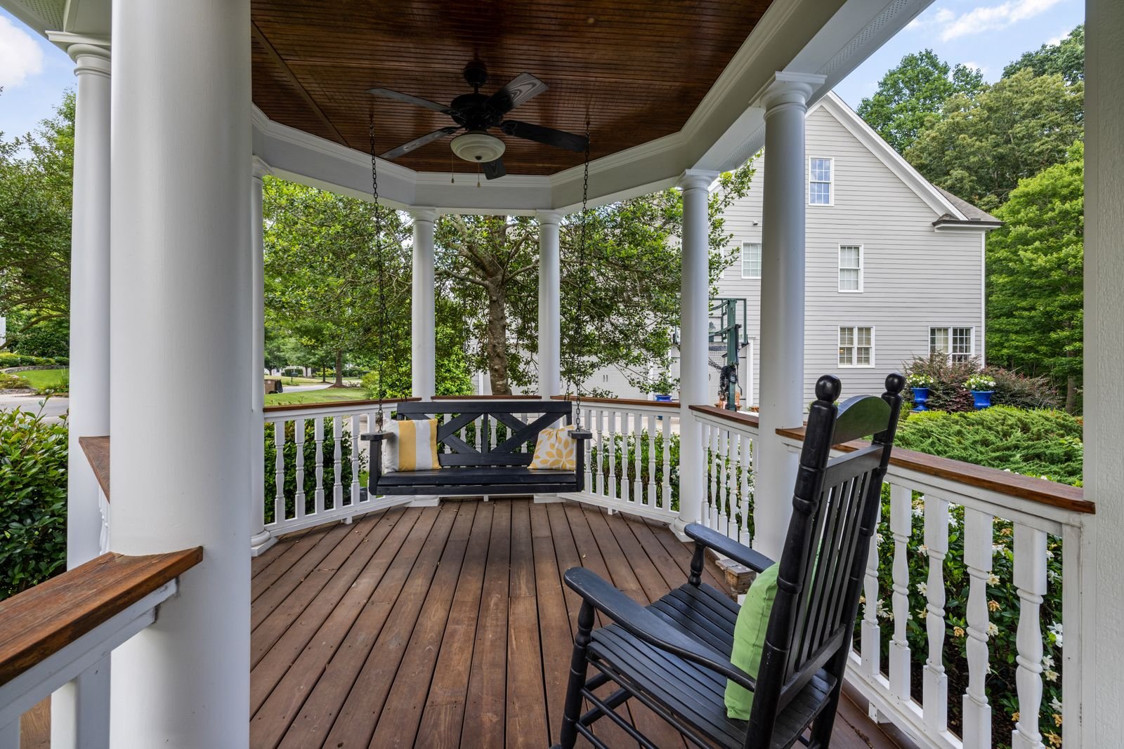 Covered porch with rocking chairs and a ceiling fan